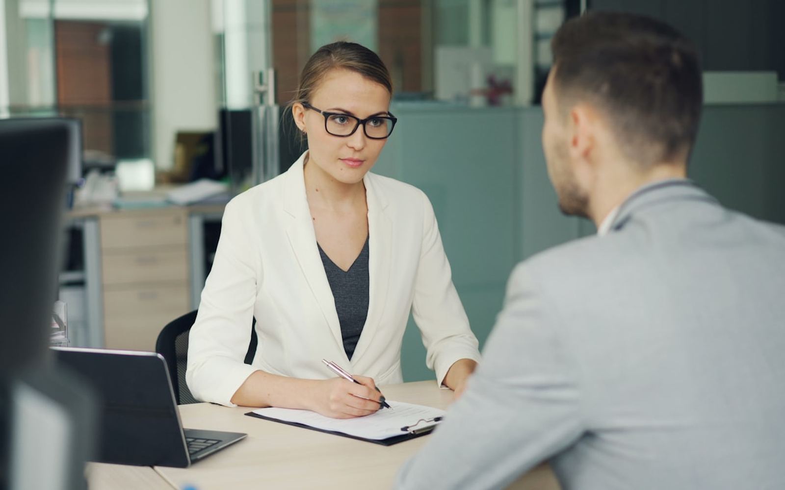 Two people in an interview across an office desk